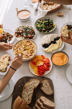 People sharing diverse food platters at a meal
