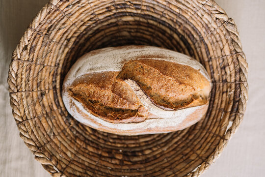 Freshly baked bread loaf nestled in a woven basket