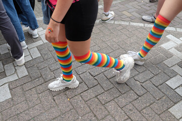 Anonymous person walking on the street in pride themed socks