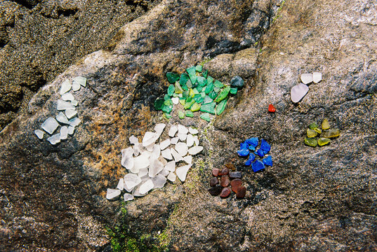 Film Photo of Sea Glass Organized by Color on a Rock in Maine