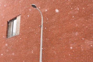 Street light on the brick wall in Winter
