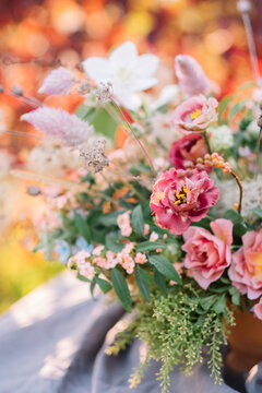 Focused view of varied flowers in fall arrangement