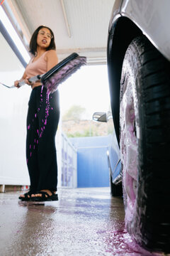 Woman Washing Car Tire