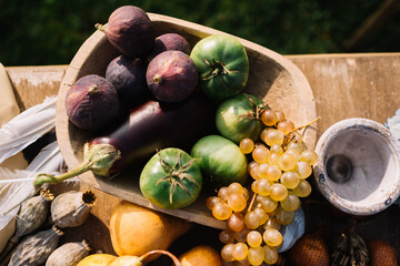 Bowl of fruits and vegetables on wooden table outdoors