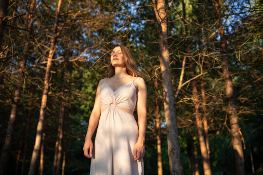 Woman with eyes closed in the woods