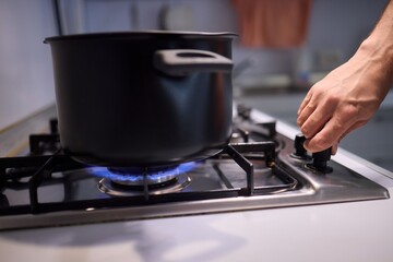 Cooking delicious meals on a modern gas stove using a sleek black pot is an art