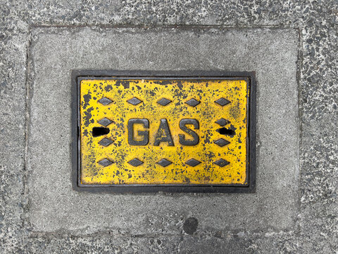 Gas sign on sidewalk