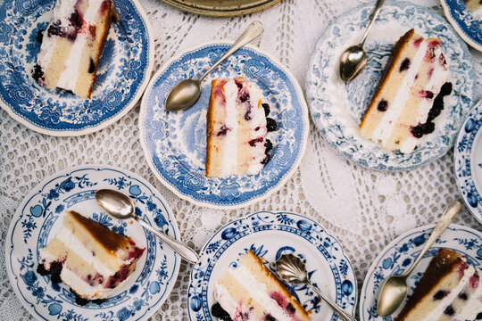 Close-up of berry cake slices on blue-patterned plates