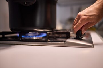 Cooking delicious meals on a modern gas stove using a sleek black pot is an art