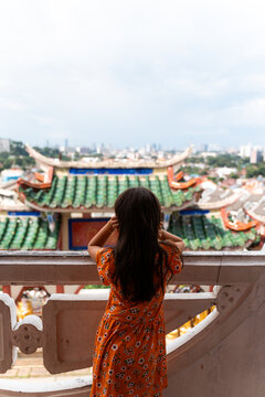 Girl overlooking Penang city from Kek Lok Si Temple, Malaysia