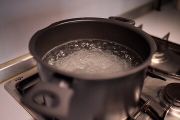 Boiling water in a pot placed atop the stove can create bubbles and steam during cooking