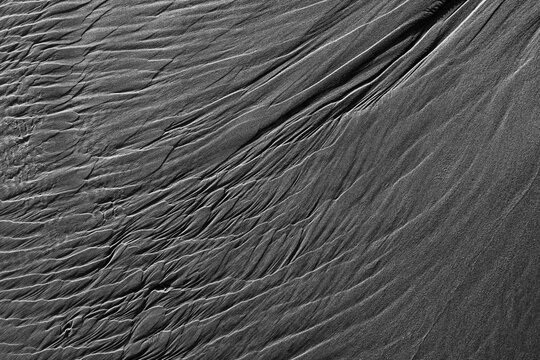 Patterns in beach sand at low tide