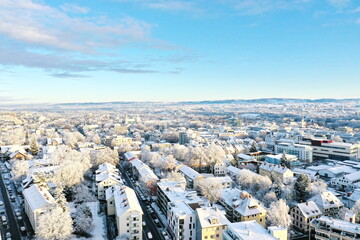 A snowy cityscape with a blue sky in the background