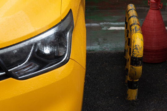 Yellow car beside yellow fence