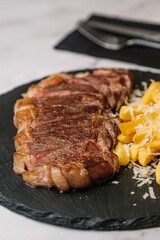 Delicious Steak Bite on Fork with Garnish in Background