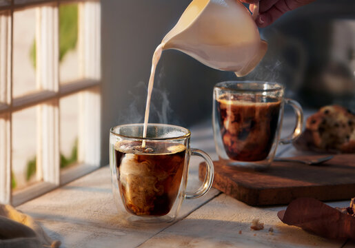 Pouring Cream into Coffee in the Morning 