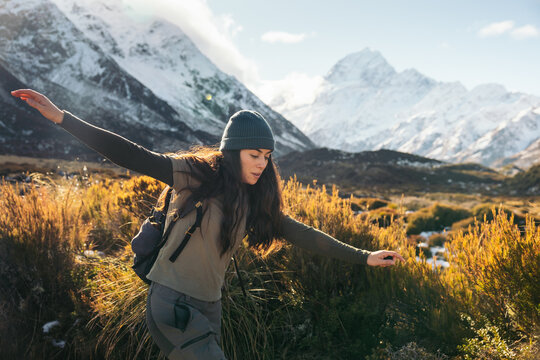 Woman about to fall hiking in mountain