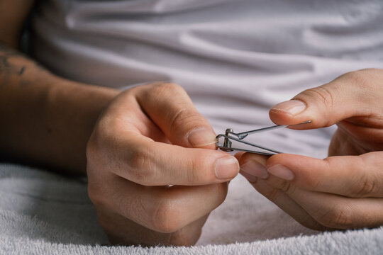 Man Cutting his Nails 