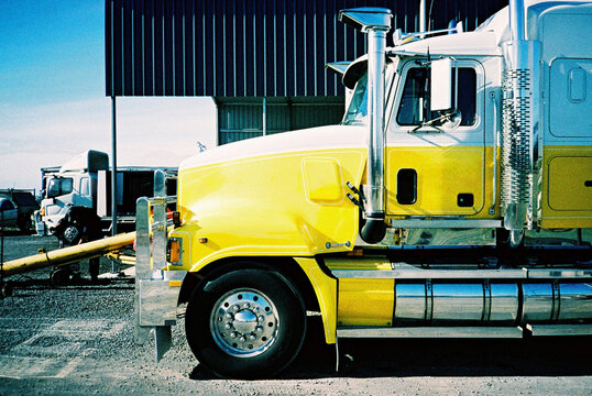 Yellow Truck Parked at Industrial Site