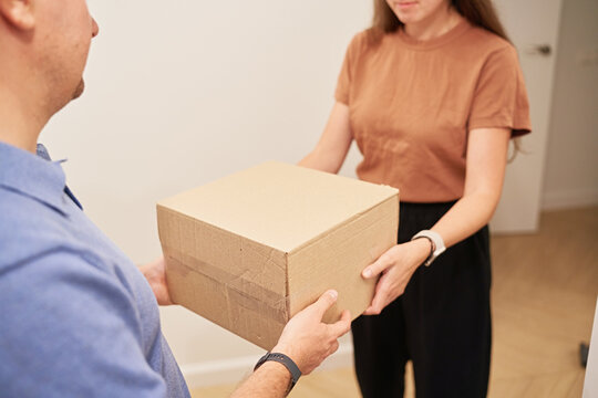 Delivery of Package Between Two People Indoors