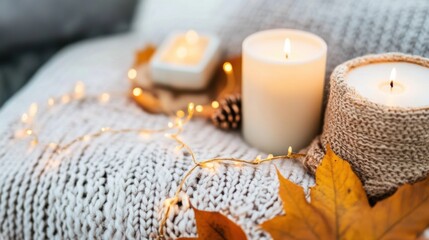 A couple of candles sitting on top of a blanket
