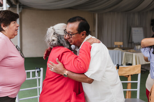 Portrait of two old men greeting each other.