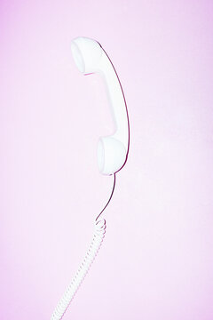 Old landline phone on office desk with hard direct flashlight