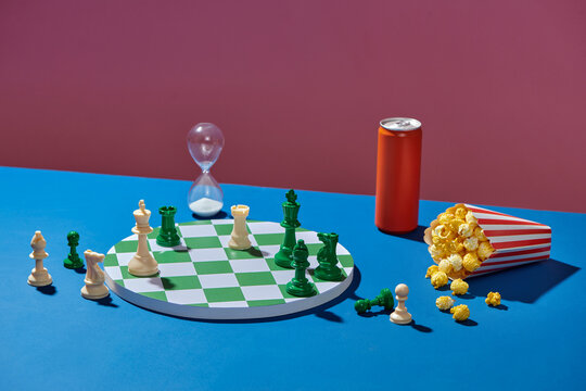 Chess Game Setup with Popcorn, Soda, and Hourglass Timer
