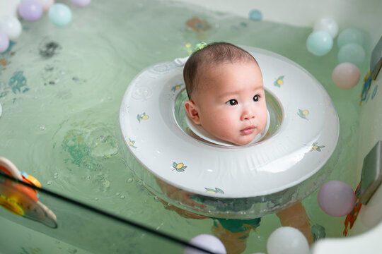 Adorable Baby Floating in a Tub with Neck Float Ring