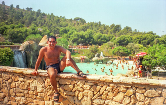 portrait with anological film of man in the pool having fun