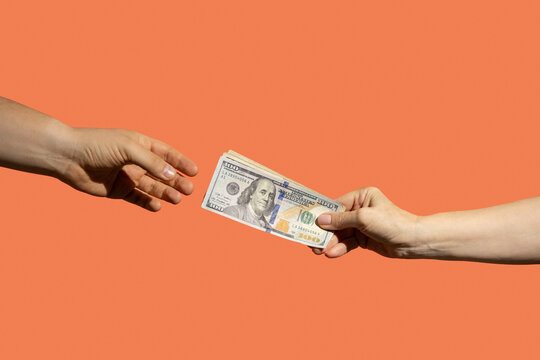 Two people passing money