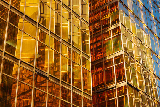 Close-Up of Glass Building with Golden Reflections and Geometric Patte