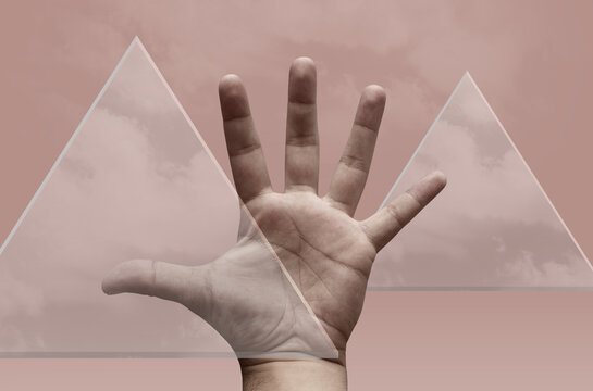 Hand of a man and glass triangles