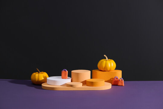 Minimalist Halloween Podium Display with Pumpkins and Bags