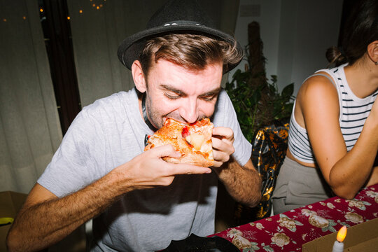 Man enjoying Halloween pizza - Powered by Adobe