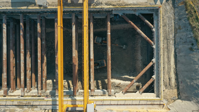 Excavation work at metro station construction surrounded by struts
