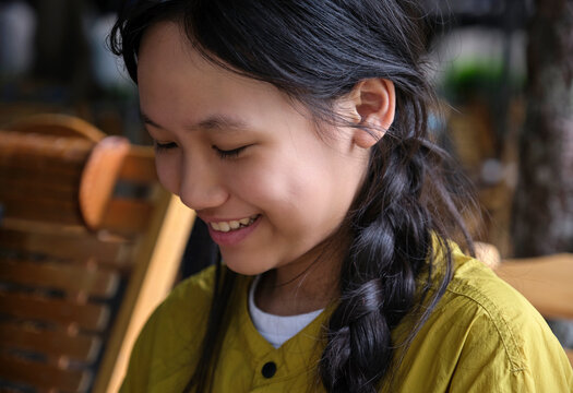 Closeup of an Asian girl drinking Chinese tea in an outdoor teahouse