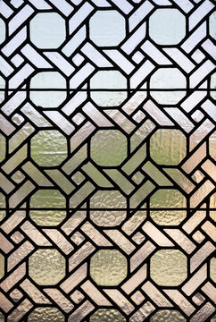Geometric stained glass window with intricate design and patterns