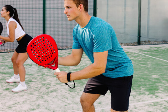 Expert padel players concentrated during a professional showdown
