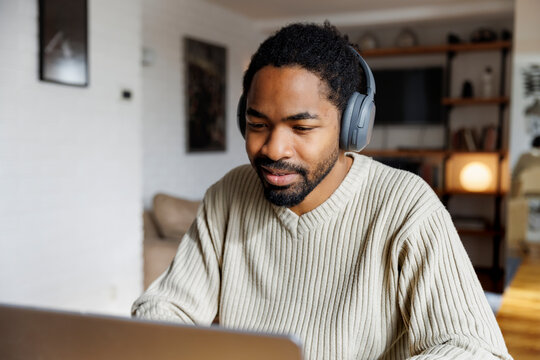 Male freelancer working on laptop at home