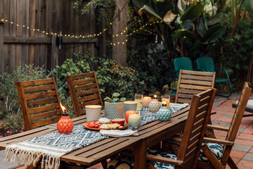 Inviting Backyard Patio with Candlelit Table and Snacks for a Co