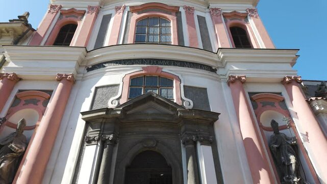 Baroque facade of Kostel sv. Jana Nepomuck&eacute;ho in Kutn&aacute; Hora, Czech Republic, under bright skies