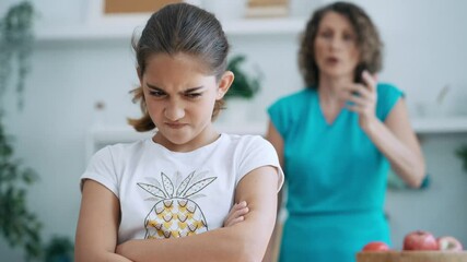Video of angry mother and daugther arguing in the kitchen at home