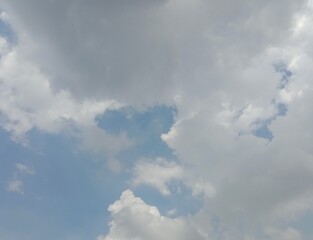 Grey clouds on blue sky in daytime. Cloud background. Presentation.