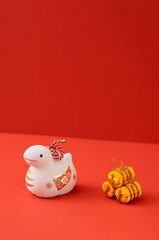 Japanese new year material. Zodiac Snake. Snakes ornament on the red background. 日本のお正月素材。干支の巳（ヘビ）。赤背景上の巳の置物
