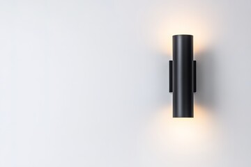 Modern black wall light illuminating white surface