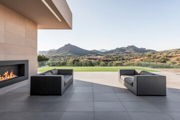 Fototapeta premium Modern outdoor seating area overlooking mountains in serene landscape under clear sky
