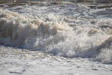 Seashore, small stones, sea wave. Marine background.