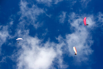 Paragliders above the alps in the dolomites, South Tyrol