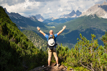 Man traveler traveling alone in breathtaking landscape of Dolomites Mounatains. Travel lifestyle...